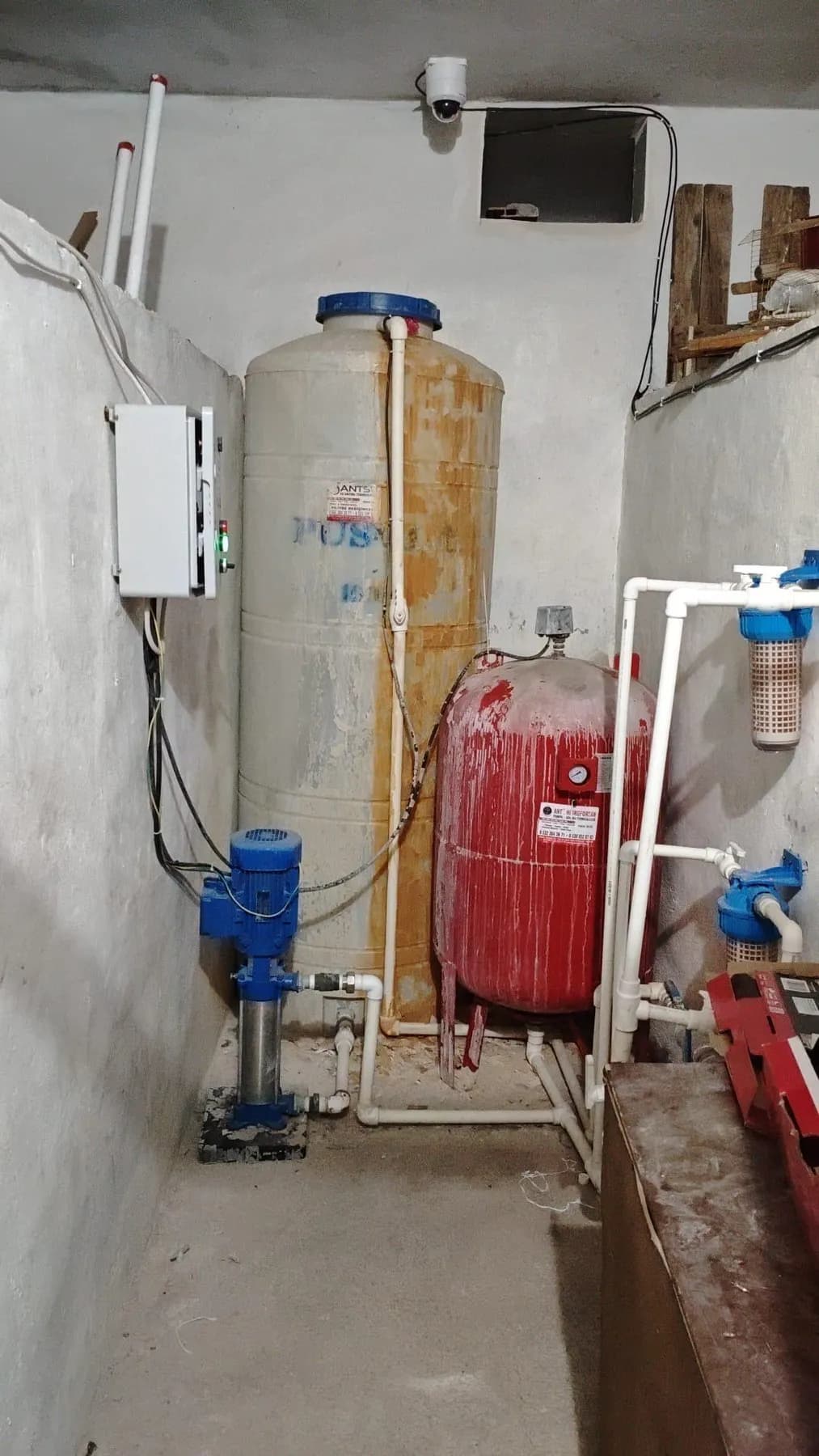 Dar bir tesisat alanında basınç tankları ve pompa bağlantıları
